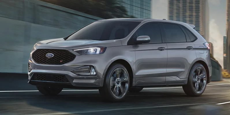 A silver 2024 Ford Edge driving down the road near Macomb, IL.