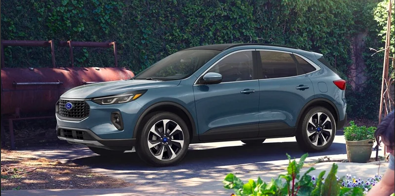 The side profile of a 2024 Ford Escape parked in a driveway near Woodrum Automotive in Macomb, IL.