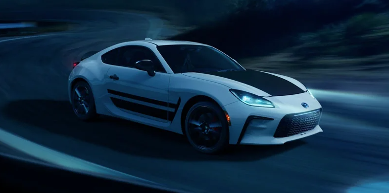 A white and black 2024 Toyota GR86 driving down the road in Macomb, IL