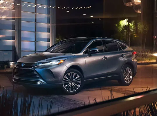 a silver 2024 Toyota Venza parked in a driveway near Woodrum Automotive.