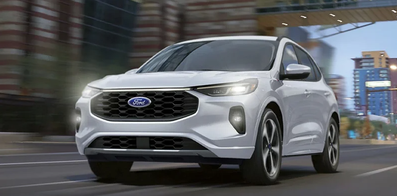 A silver 2025 Ford Escape driving down the road.