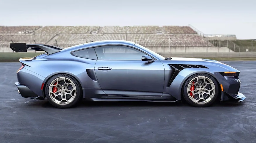 A silver 2025 Ford Mustang parked in a parking lot.