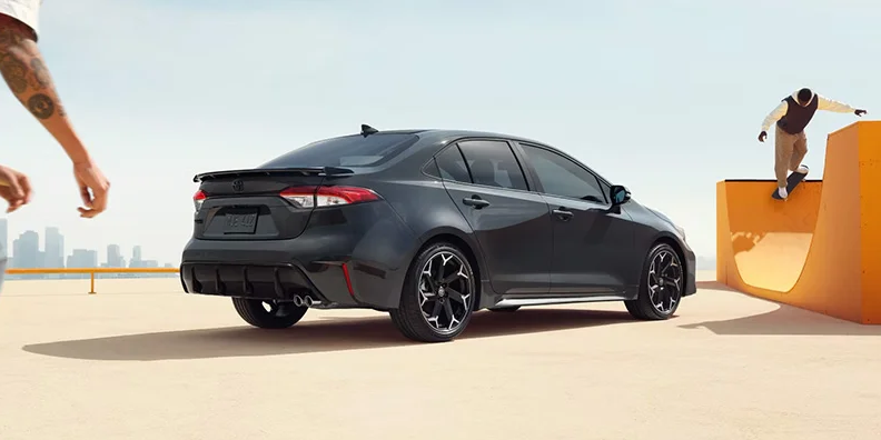 A black 2025 Toyota Corolla parked next to a halfpipe.