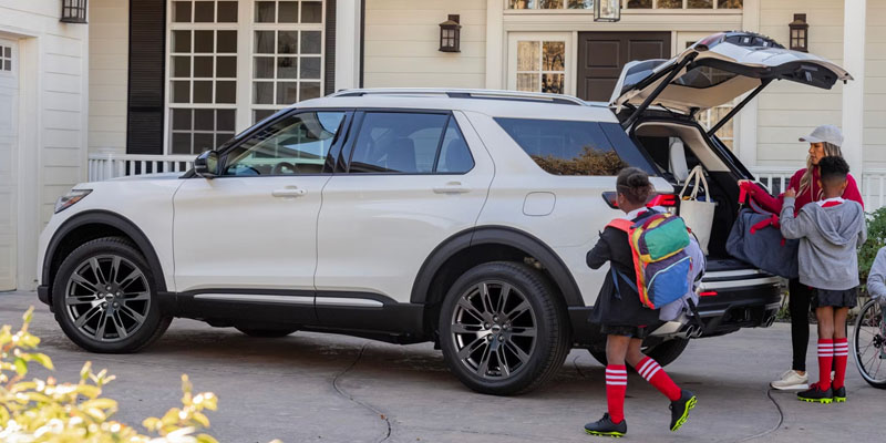 White 2026 Ford Explorer parked outside home children's keeping the luggage in bootspace